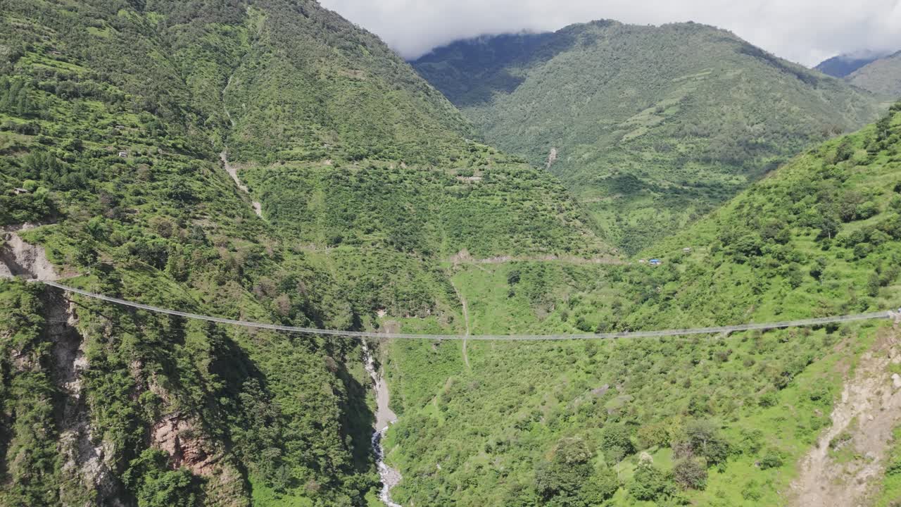 wire bridge in Nepal with beautiful mountain
