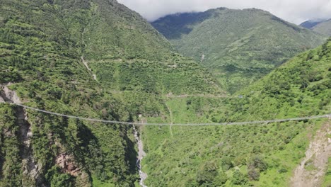 wire bridge in nepal with beautiful mountain