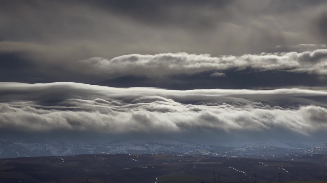Time Lapse of Dramatic Storm Clouds Over Snowy Mountains