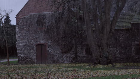 a creepy scary old rustic historic house exterior in the rain