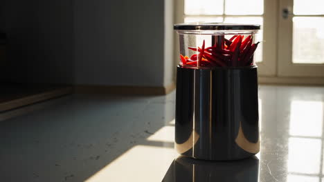 red chili peppers in a container with sunlight