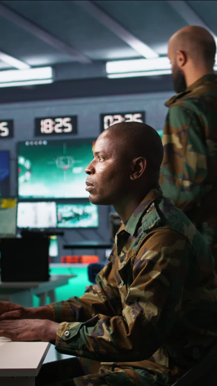 Vertical video Intelligence operative in military base doing surveillance with radar