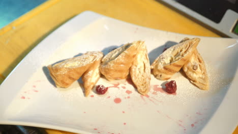 chef decorating delicious dessert. chef putting finishing touch on dessert in commercial kitchen