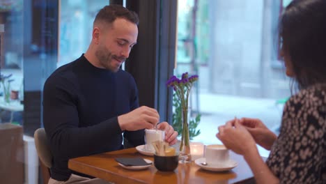 content couple drinking coffee in cafe