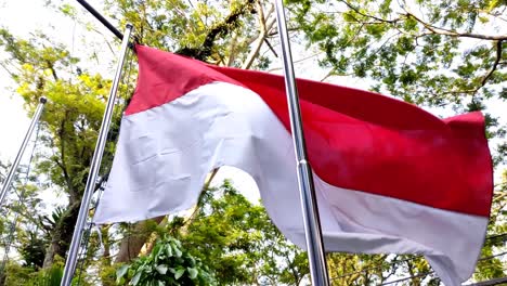 indonesia's national flag with red and white colors fluttering in the wind during the day