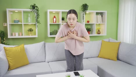 asian young woman experiencing chest pain or tightness.