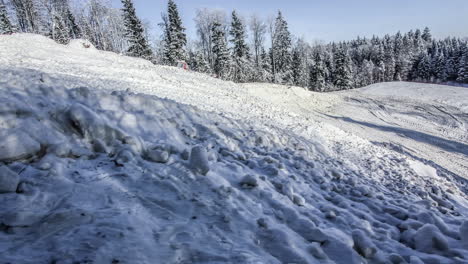 machinery preparing skiing track in winter wonderland, fusion time lapse on sunny day