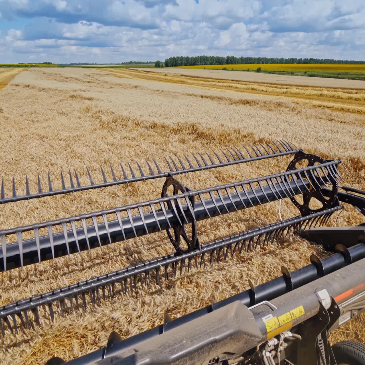 Combine harvester works on a beautiful landscape of nature. Metal part of agricultural machine on the field during seasonal works.