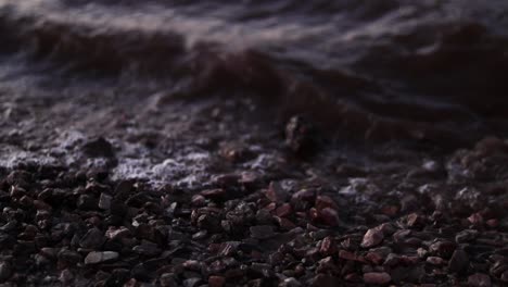 Waves flow over pebbles on a riverbank