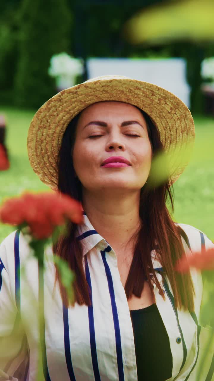 A Woman in a Straw Hat Finds Serenity Amidst Vibrant Flowers, Embracing Nature's Beauty and the Calmness of the Outdoors