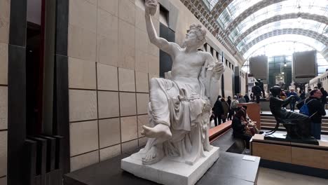 people observing statues in a museum