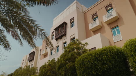 Discover-a-house-in-Al-Furjan-Community,-Dubai,-featuring-lush-trees,-greenery,-flowers,-and-distinctive-architecture,-blending-modern-design-with-natural-surroundings