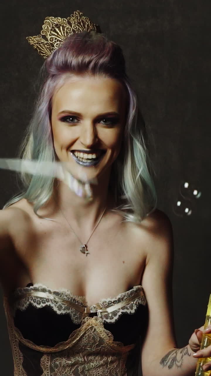 Woman blowing soap bubbles. Young beautiful girl blowing bubbles in a studio