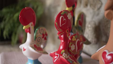 hand painted portuguese rooster figurines adorned with vibrant colors and heart motifs, symbolizing love and tradition