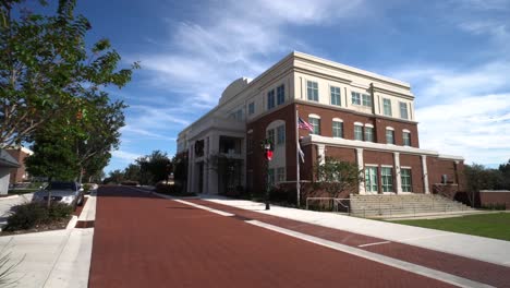 wide angle push in establishes historic downtown clermont official city office building