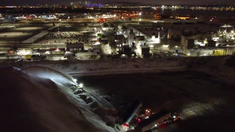 Heavy-work-at-night,-large-snow-remover-in-Montreal,-Canada