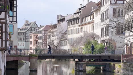 the pont du faisan spans the canal of the river ill in the petite france quarter lined with half-timbered houses - strasbourg, france