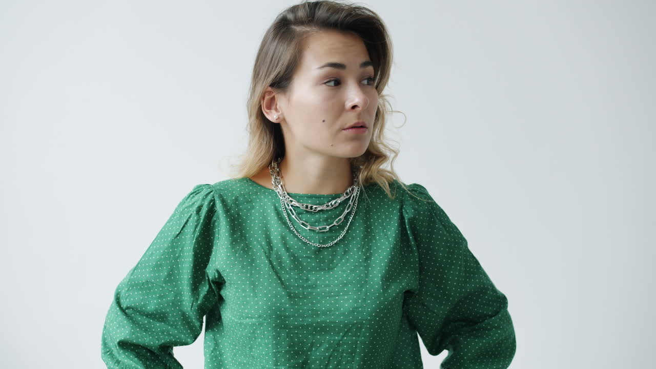 Woman in a Green Polka Dot Shirt with Chains