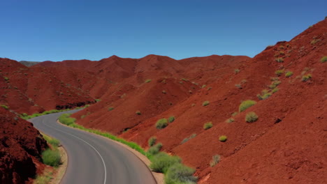 winding road through red rock desert mountains