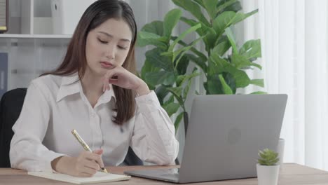 enthusiastic businesswoman working and typing laptop in the office.