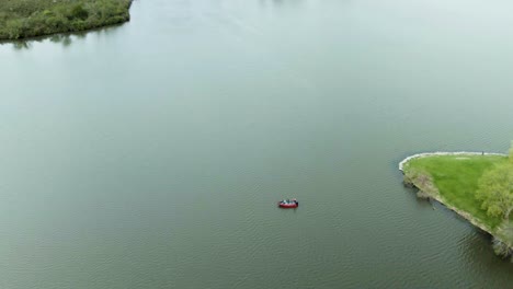 an aerial shot of a couple of small fishing boats on tampier slough lake in illinois