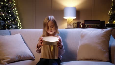 Portrait-Of-Joyful-Little-Cute-Girl-Opening-Christmas-Gift-Box-With-Surprised-Happy-Face