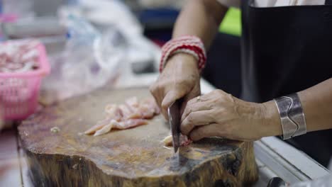 woman chopping meat