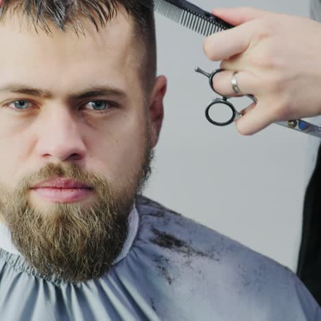 man getting hair cut in a barbershop