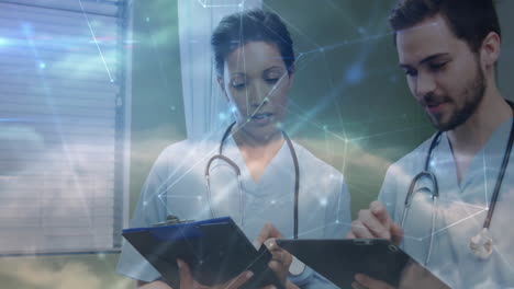doctors reviewing clipboard and tapping tablet in health clinic, adding network overlay