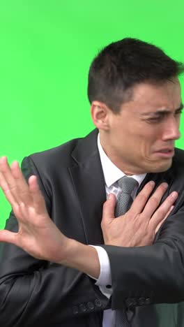 man suffering from chest pain on green screen