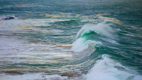 stormy ocean barrels rolling in white foam. huge dark waves swelling on shallow