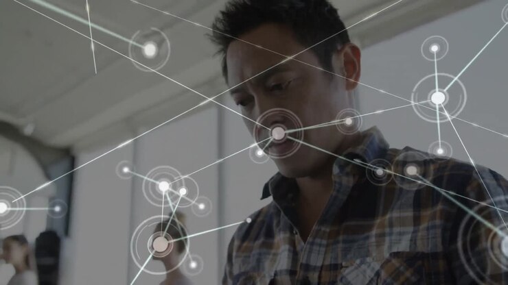 Animation of networks of connections over biracial businessman using smartphone