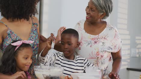 video of african american family cooking together in the kitchen