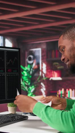 vertical video male investor clapping hands in excitement after gaining money by selling stock