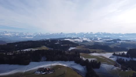drone flight over a typical swiss landscape with the breathtaking alps in the background