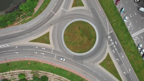 busy urban traffic. aerial top view traffic on circle road in city at day. 4k stock footage.