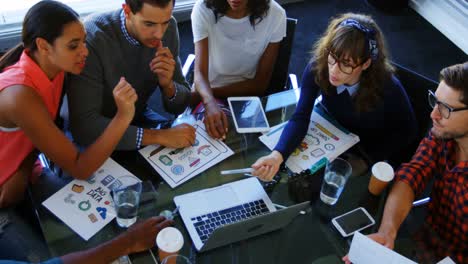 Executives-discussing-over-laptop