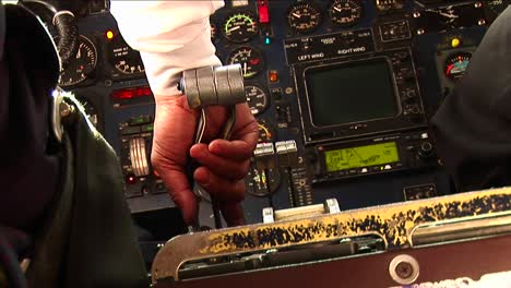 pilots hands on the controls of an small airplane landing