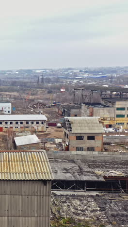 aerial view from the air to an abandoned factory. old industrial building for demolition. vertical video