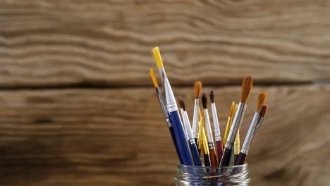 various paintbrush in plastic container