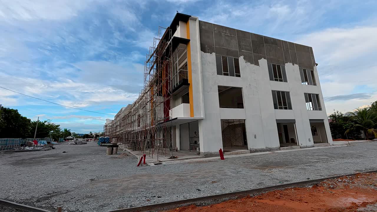 A newly built two-story shop lot in the final stage of construction with modern design, wide facade, and spacious road infrastructure.