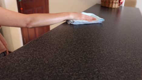 sequence of folding a towel neatly on a countertop