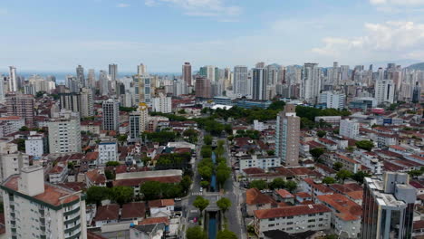 Drone-shot-following-a-channel-in-the-city-of-Santos,-quiet,-sunny-day-in-Brazil