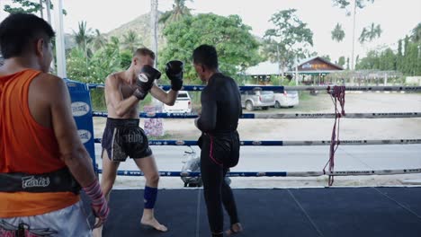 muay thai training and sparring session in an outdoor ring