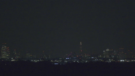 take off at london airport across the city skyline taken from a distant viewpoint with a telephoto lens