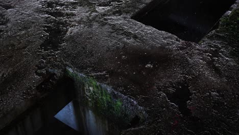 Empty-abandoned-building-skeleton,-concrete-pillars-and-pools-of-water