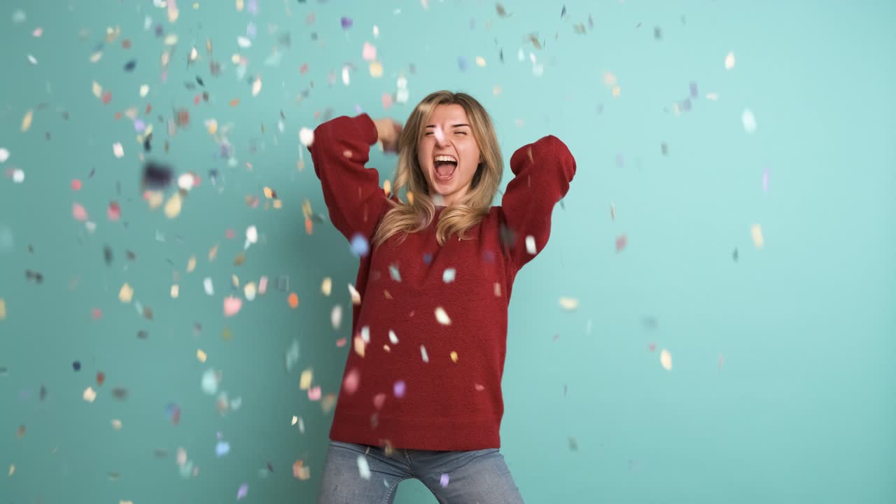 Cheerful woman celebrating big win showered in confetti