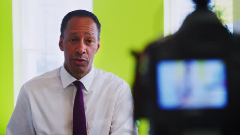 middle aged black businessman making an instructional video