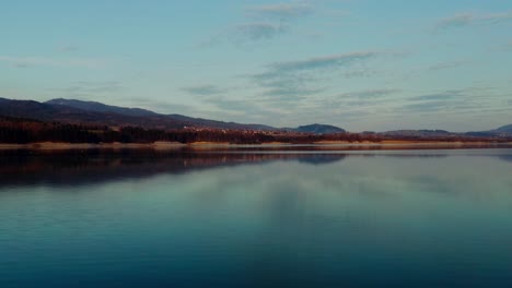 stillness of a lake with clouds reflection during sunset