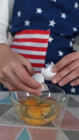 cracking eggs into a bowl